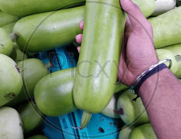 Closeup shot of a pile of zucchini in a market