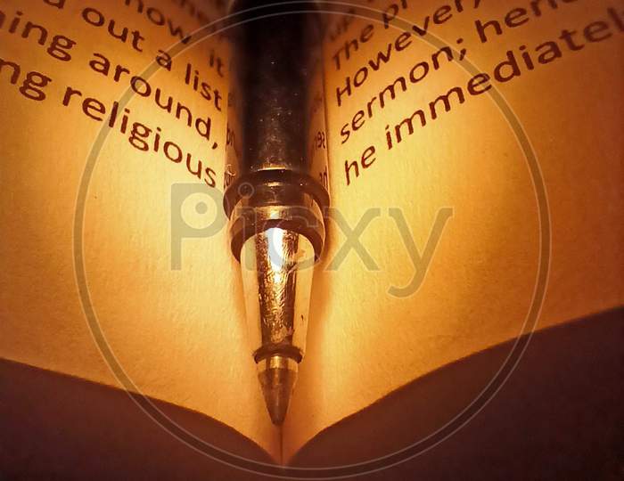 Pen on a Book with Lamp