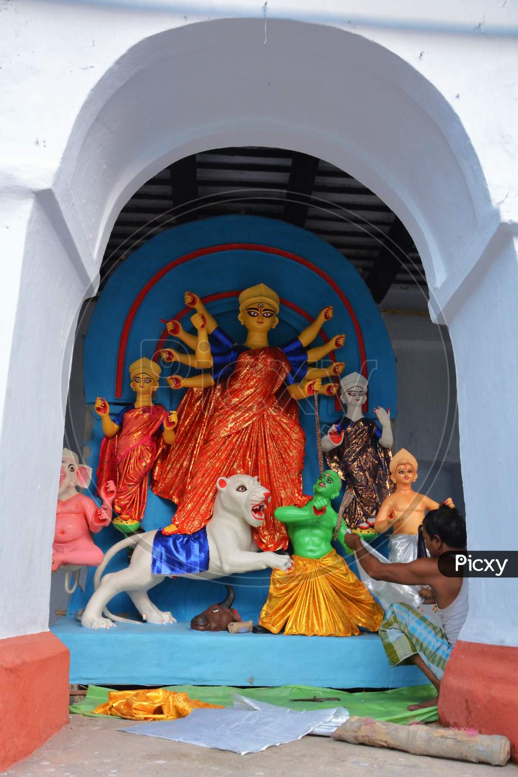 Preparation Of An Idol Of Goddess Durga With Her Ten Hands Punishing The Devil Mahisasur Accompanied By Goddess Laxmi,Saraswati, Lord Ganesha God Kartikeya