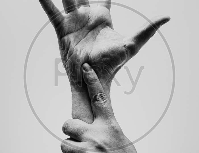 Young Hands, One Grabbing The Another, In Black And White With A Lot Of Texture