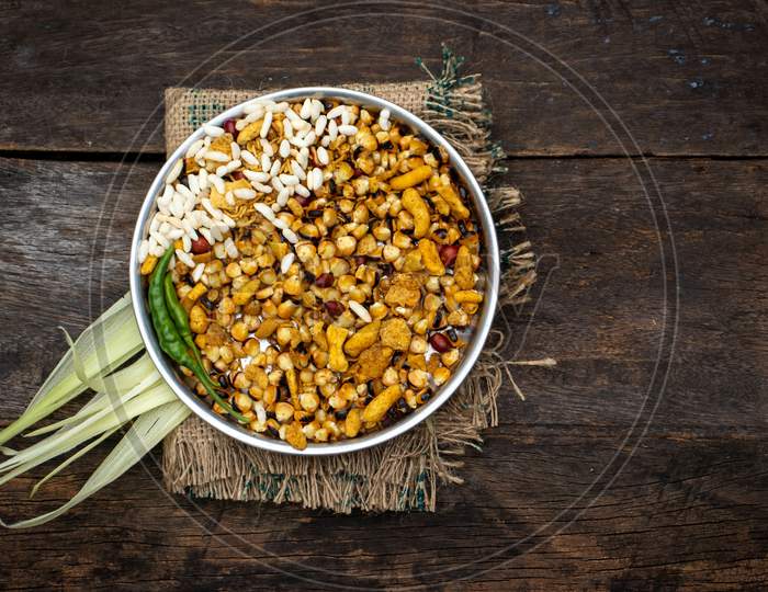 Roasted Corn Seeds And Puffed Rice With Namkeen And Spices In A Plate Isolated On Wooden Background With Copy Space