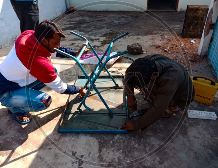 Indian Villager Repairing Work.