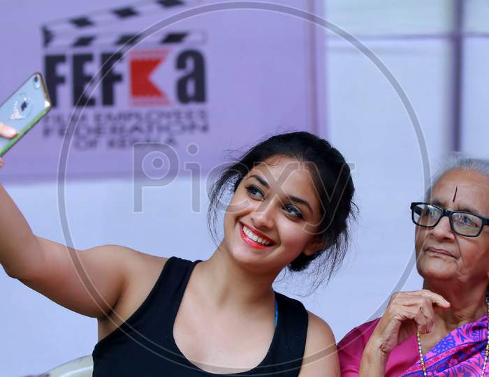 Trivandrum,Kerala/India- 06 Dec 2015 :Actress Keerthi suresh taking selfie with her grandmother during International Film Festival of Kerala, IFFK 2015,On blurred background