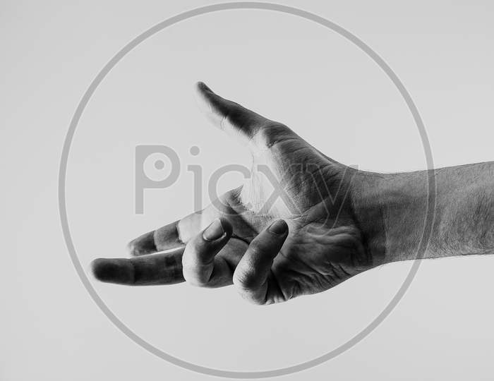 Young Hand In Black And White About To Reach Something With A White Background