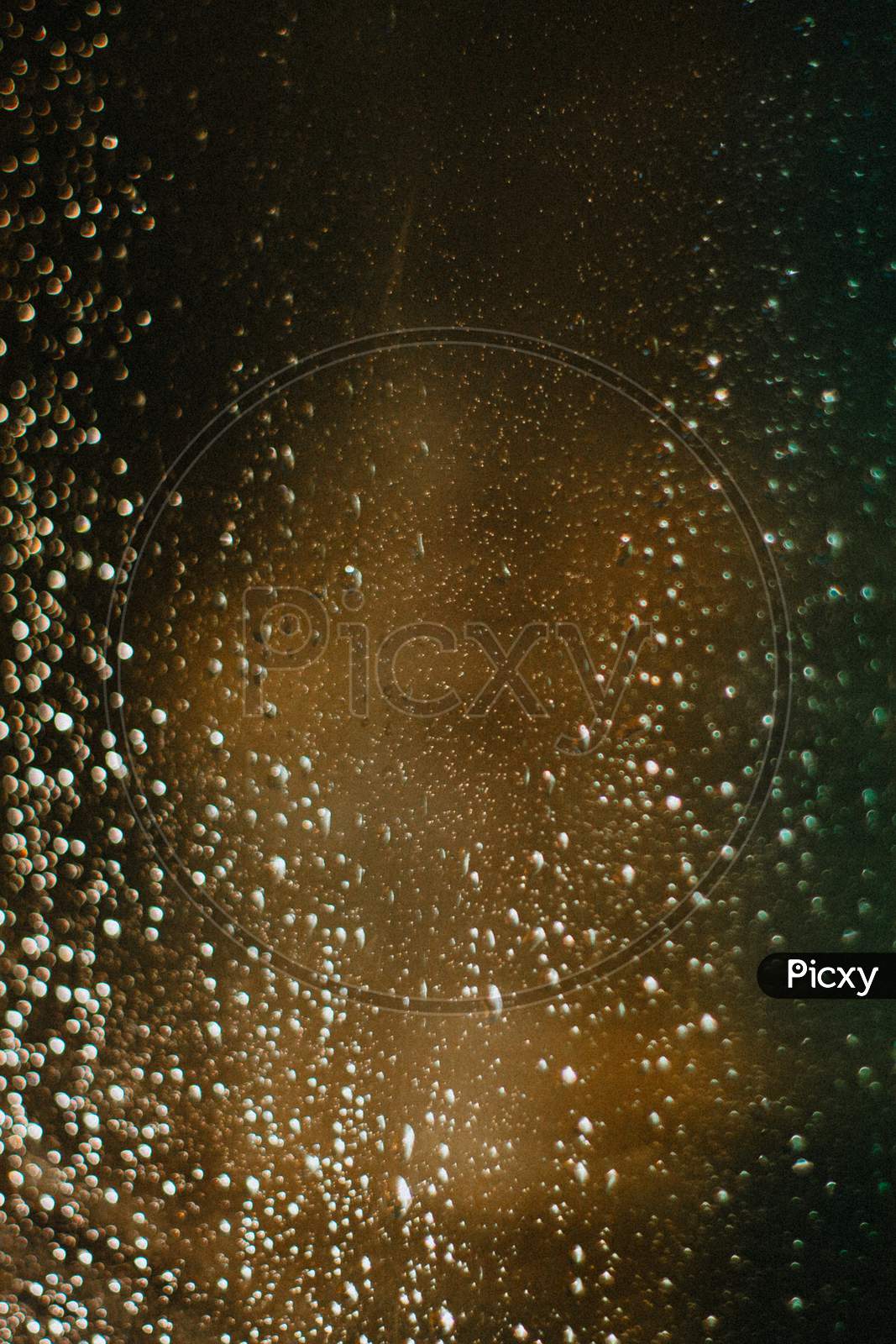 Background Of A Colorful Crystal With Water Drops In It, On Red And Green Tones