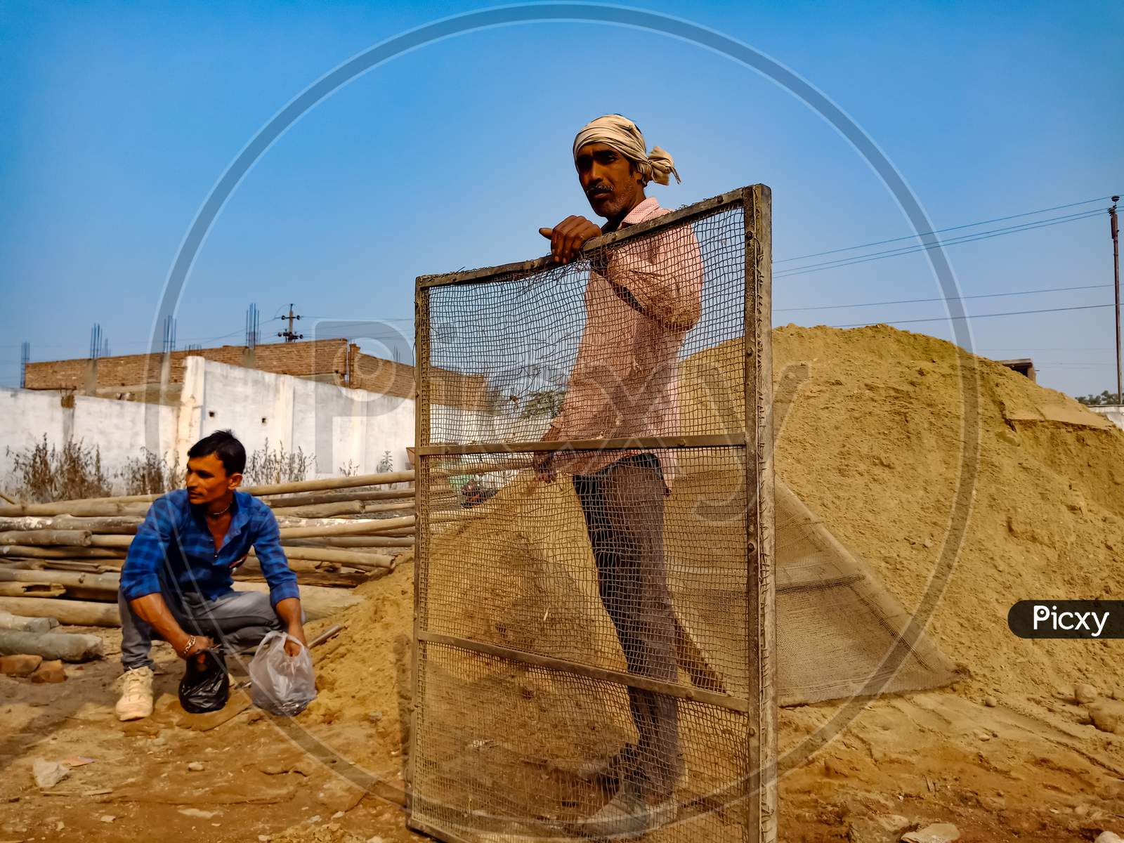 Indian Workers On Construction Site.