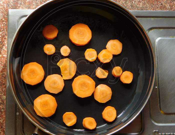 Carrots on frying pan.