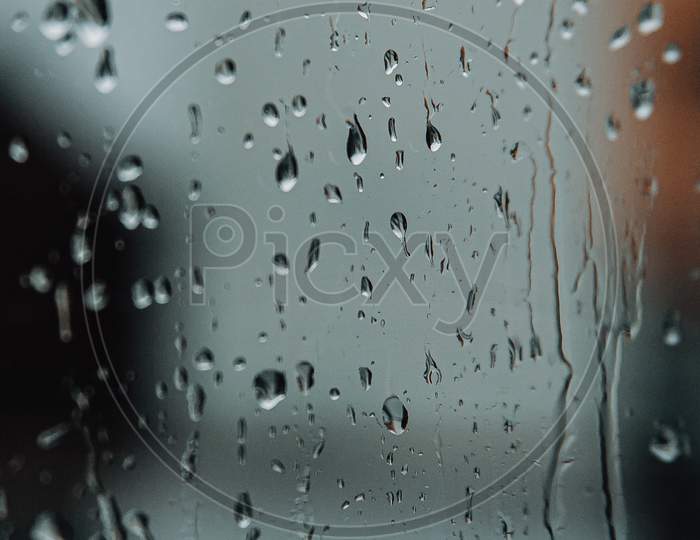 Rain Drops Over The Crystal Of A Window During A Sad Day