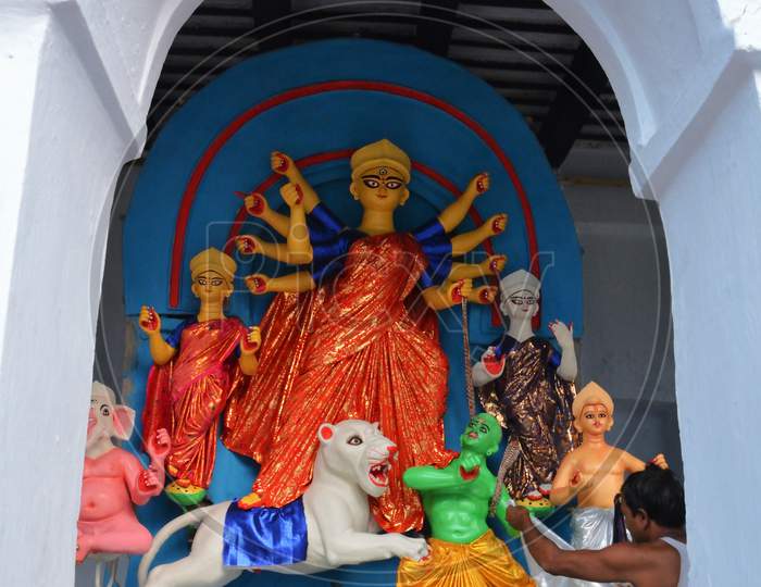 Preparation Of An Idol Of Goddess Durga With Her Ten Hands Punishing The Devil Mahisasur Accompanied By Goddess Laxmi,Saraswati, Lord Ganesha God Kartikeya