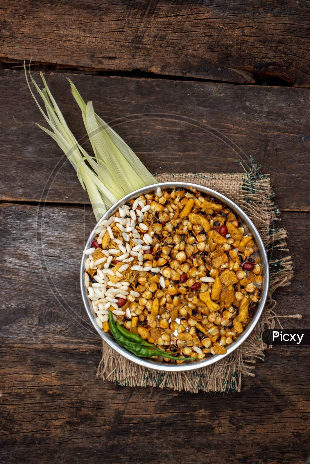 Roasted Corn Seeds And Puffed Rice With Namkeen And Spices In A Plate Isolated On Wooden Background