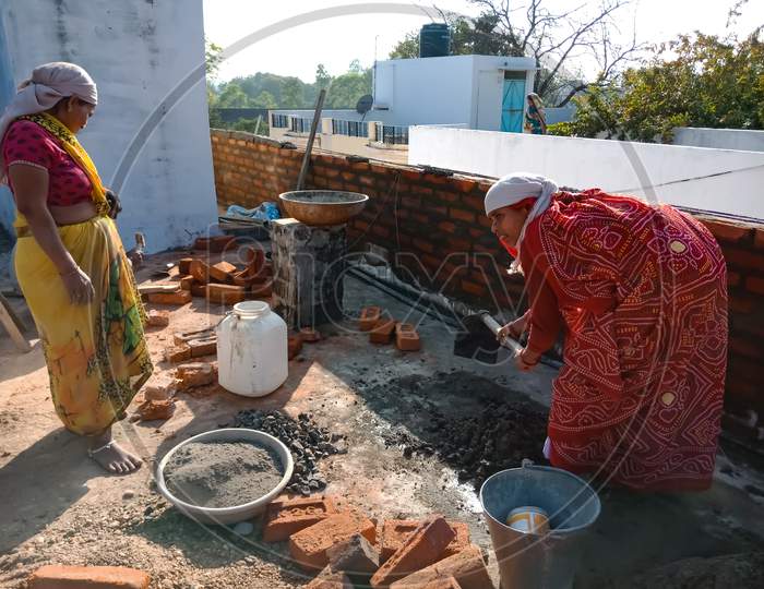 Indian Workers On Construction Site.