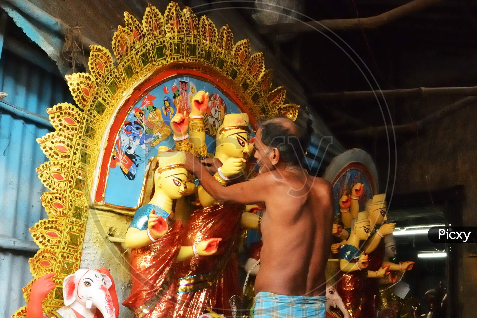 Preparation Of An Idol Of Goddess Durga With Her Ten Hands Punishing The Devil Mahisasur Accompanied By Goddess