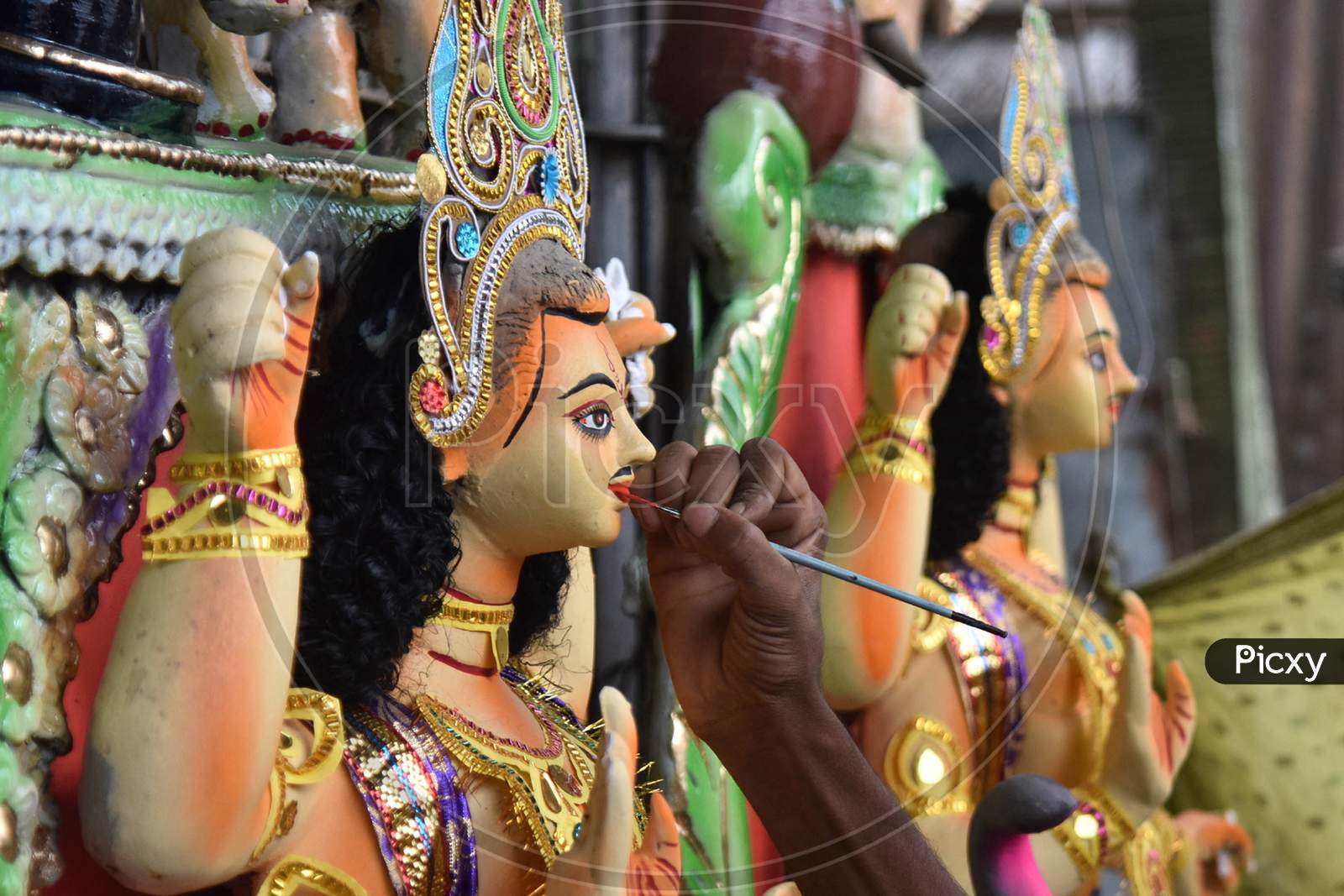 A  worker gives the final touches to a idol of Hindu God Vishwakarma a few days ahead of the Viswakarma worship day in Nagaon district of Assam on Sep 15, 2020.
