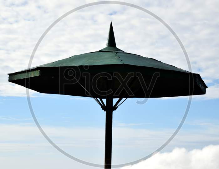 Closeup Picture Of Big Umbrella And Blue Sky In Background