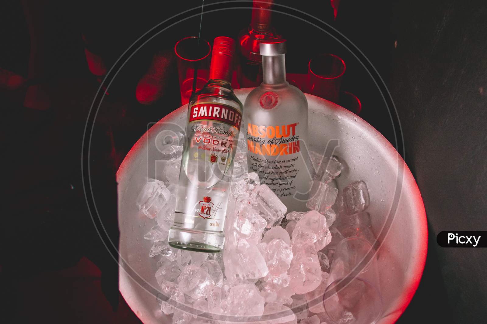 Two Bottles Of Smirnoff And Absolut Vodka In A Bowl With Ice