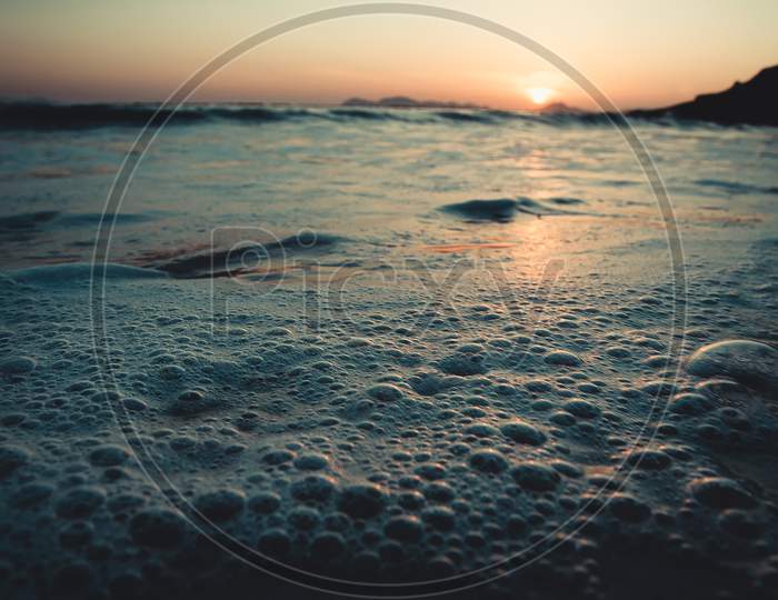 Super Close Up Of The Bubbles In The Tide Of The Beach During A Sunset