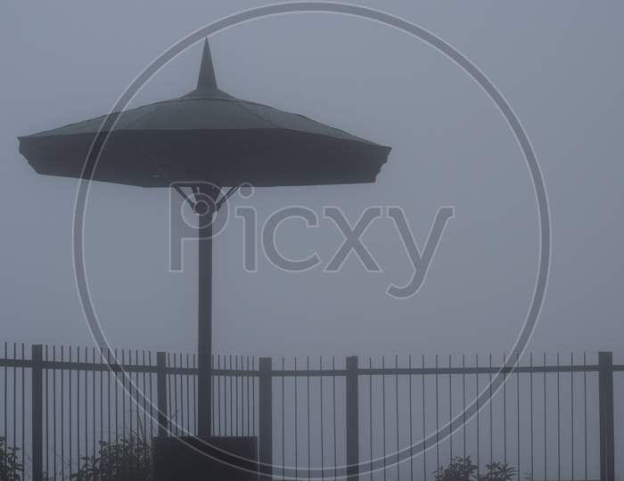 Beautiful Picture Of Umbrella Covered With Fog
