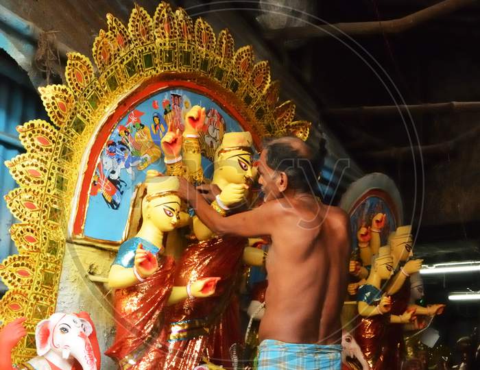 Preparation Of An Idol Of Goddess Durga With Her Ten Hands Punishing The Devil Mahisasur Accompanied By Goddess