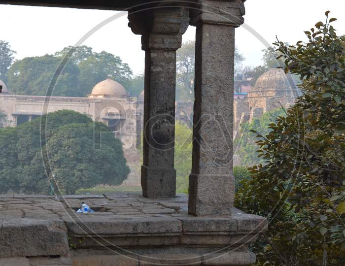 A Sun Create Some Dramatic View Of Fort, Monument At Hauz Khas Memorial From The Side Of The Lawn At Winter Foggy Morning.