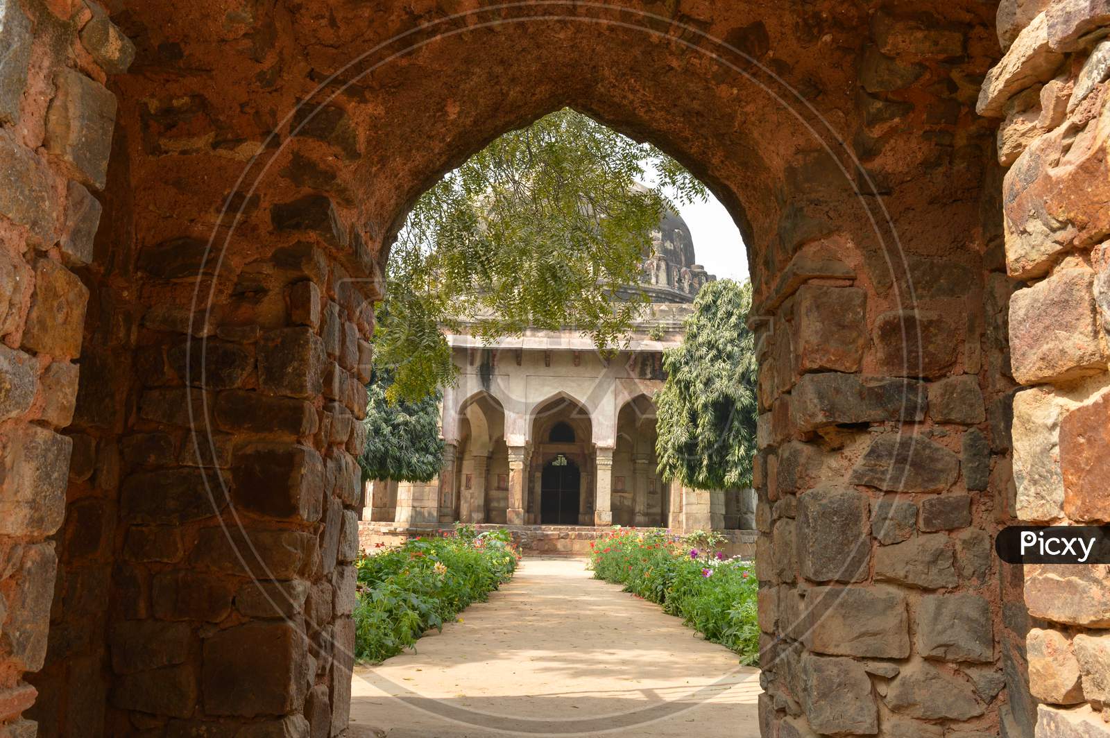 A Tomb Of Sikandar Lodhi Monument At Lodi Garden Or Lodhi Gardens In A City Park From The Side Of The Lawn At Winter Foggy Morning.