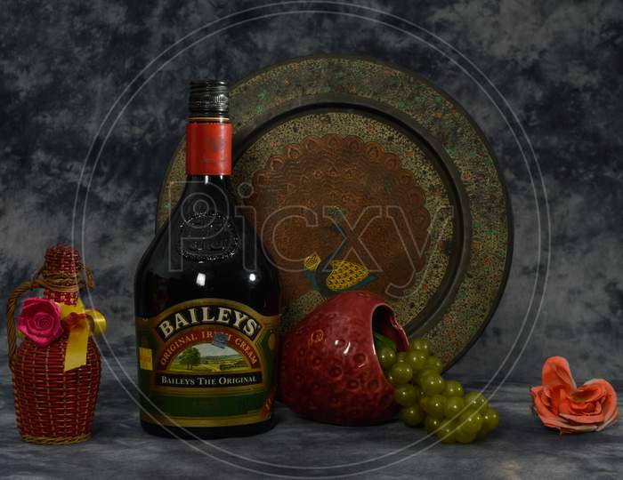 Still Life With Baileys, Grapes, Flower Isolated On The Cloth Background With Art Work