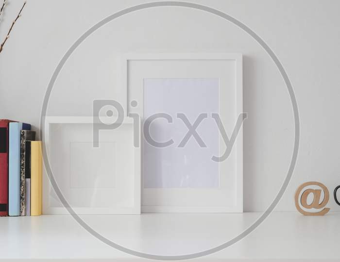 Minimal Workspace With Mock Up Frame And Office Supplies On White Wooden Table