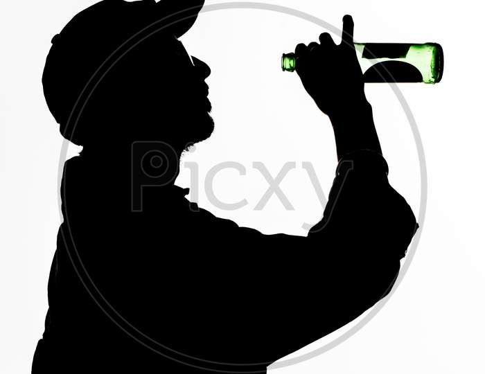 A Silhouette Of Men Who Is Drinking Beer