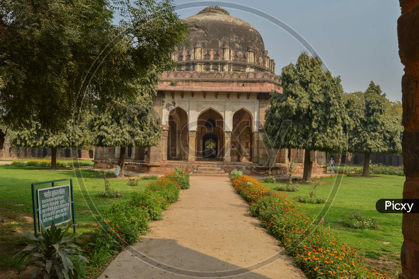 A Tomb Of Sikandar Lodhi Monument At Lodi Garden Or Lodhi Gardens In A City Park From The Side Of The Lawn At Winter Foggy Morning.