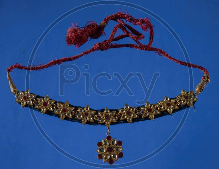 Beautiful Antique Indian Necklace Isolated On Blue Background With Diamond And Stone