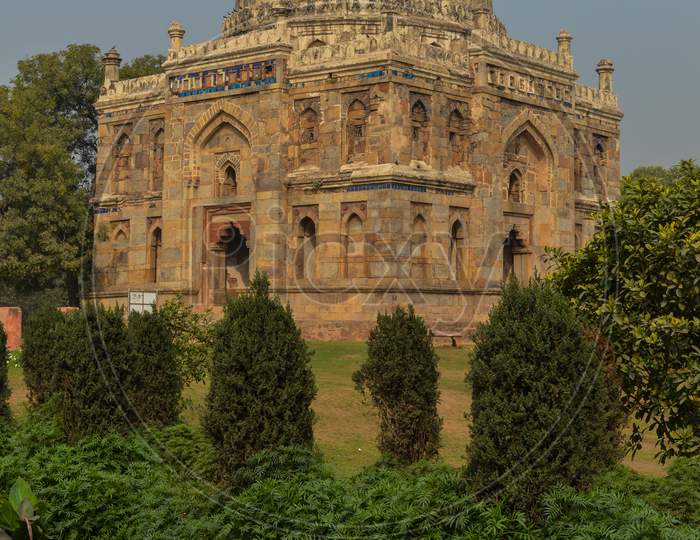 A Shish Gumbad Monument At Lodi Garden Or Lodhi Gardens In A City Park From The Side Of The Lawn At Winter Foggy Morning.