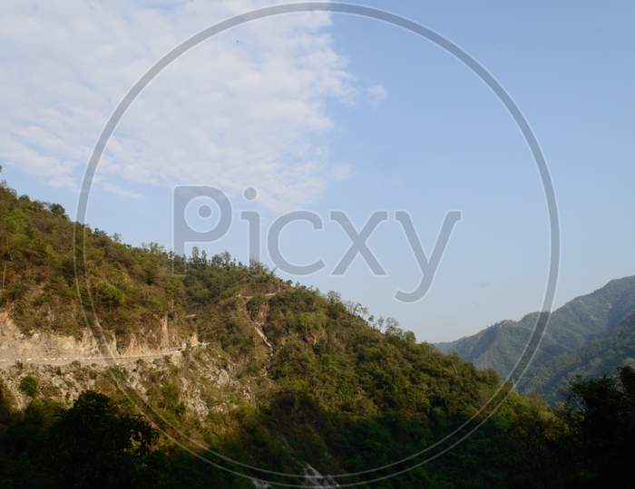 The View Of Mountain, Blue Sky, Greenery, The Beauty Of Nature Of The Famous Neer Waterfall, Rishikesh, Uttarakhand, India.