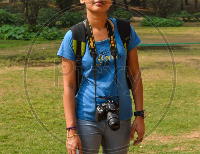 A Portrait Of Student Of Photography At Lodhi Garden Park With Nikon Camera.
