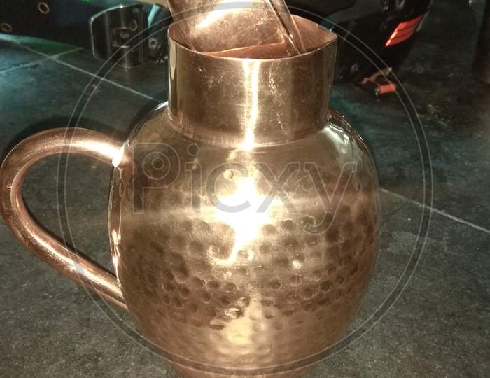 Brass jug with handle