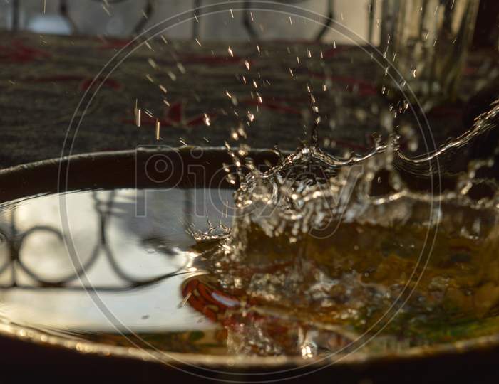 A Splash Photography Of Water Of Glass At Sunset Time.