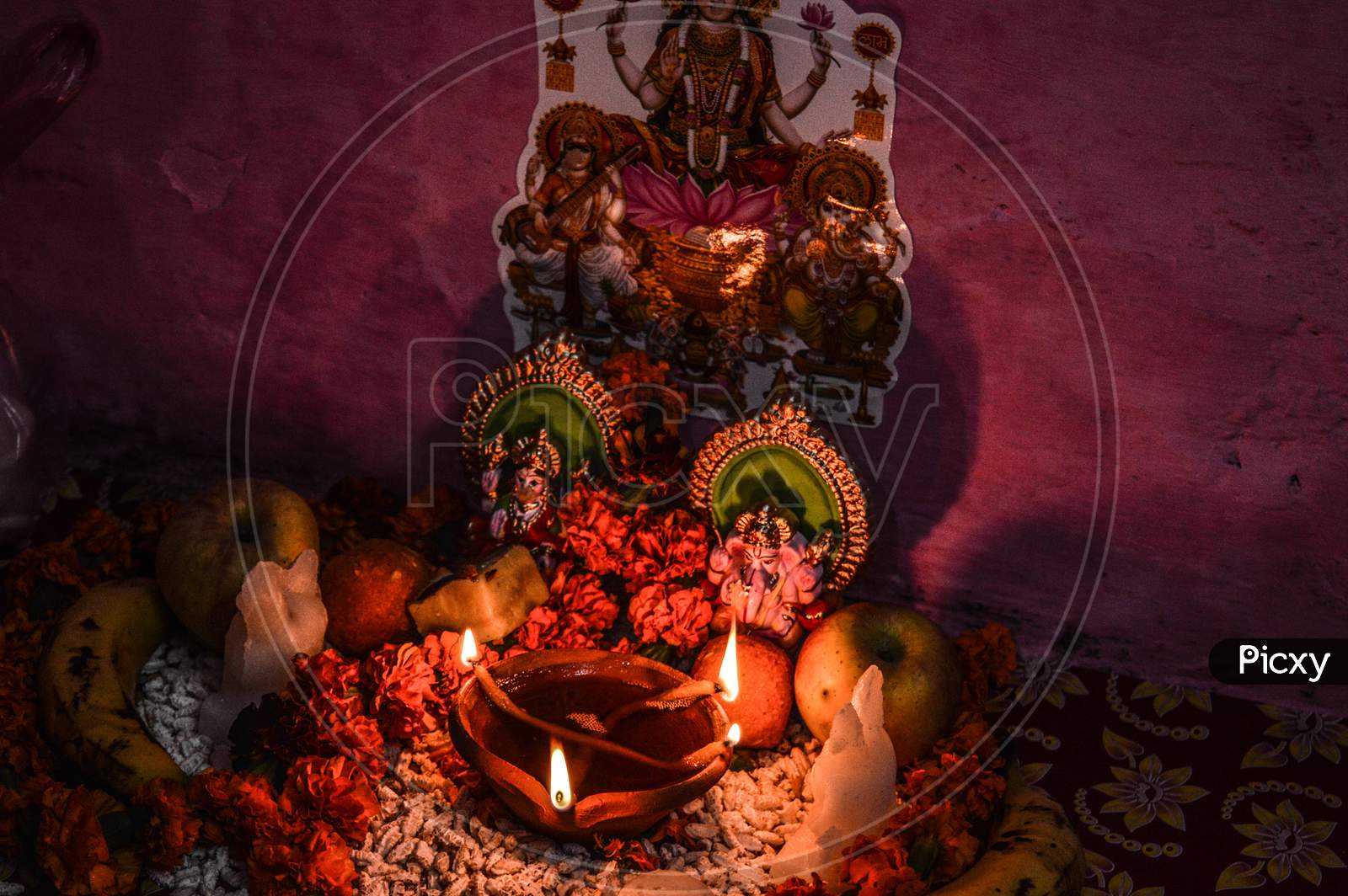 Indian God Statue With Rose And Candle On Indian Festival Diwali Deepawali With Fire Isolated On Table