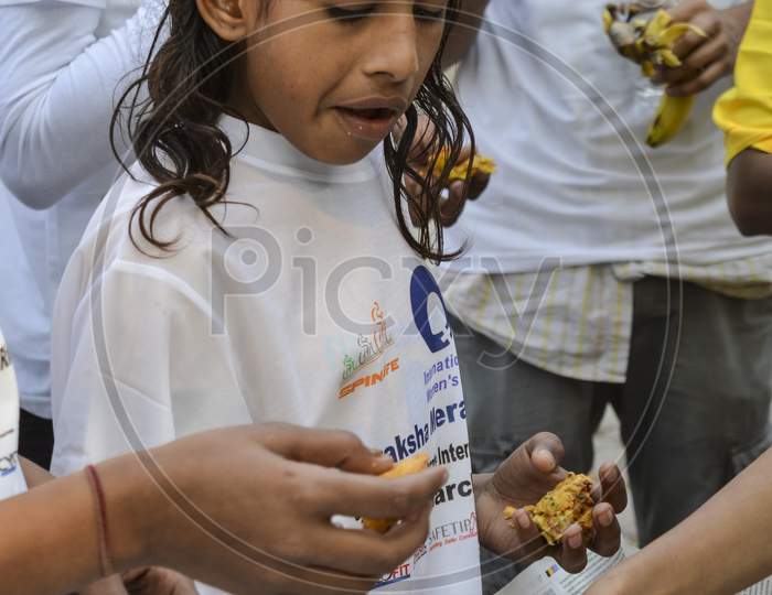 A Indian Girl Having The Food At Event For Support The Cycle Ride To Celebrate International Women'S Day.