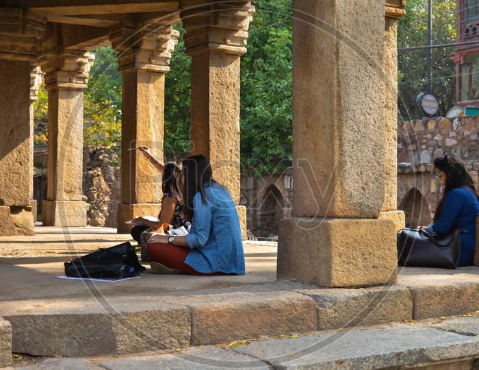 A Bunch Of Girls Is Drawing The Hauz Khas Monument And Garden From The Hauz Khas Fort At Hauz Khas Village At Winter Foggy Morning.