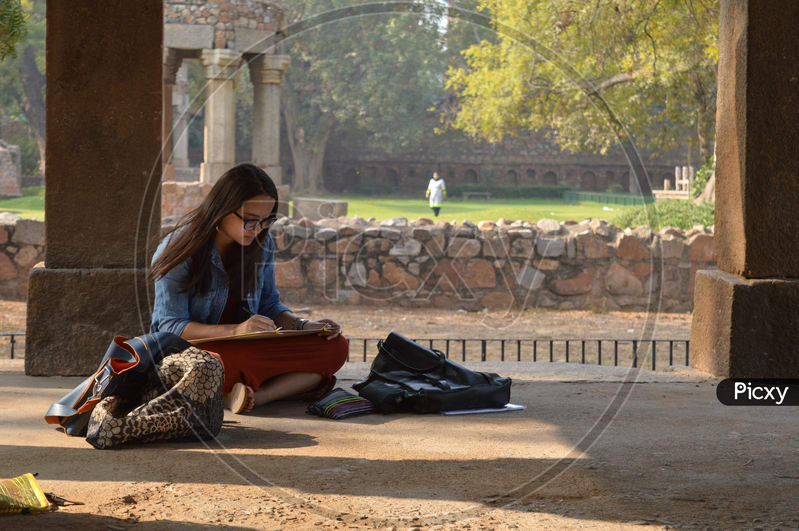 A Girl Is Drawing The Hauz Khas Monument And Garden From The Hauz Khas Fort At Hauz Khas Village At Winter Foggy Morning.
