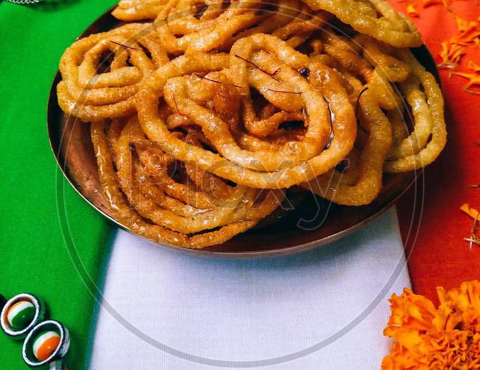 A plate of indian national sweet, crispy and juicy jalebi.