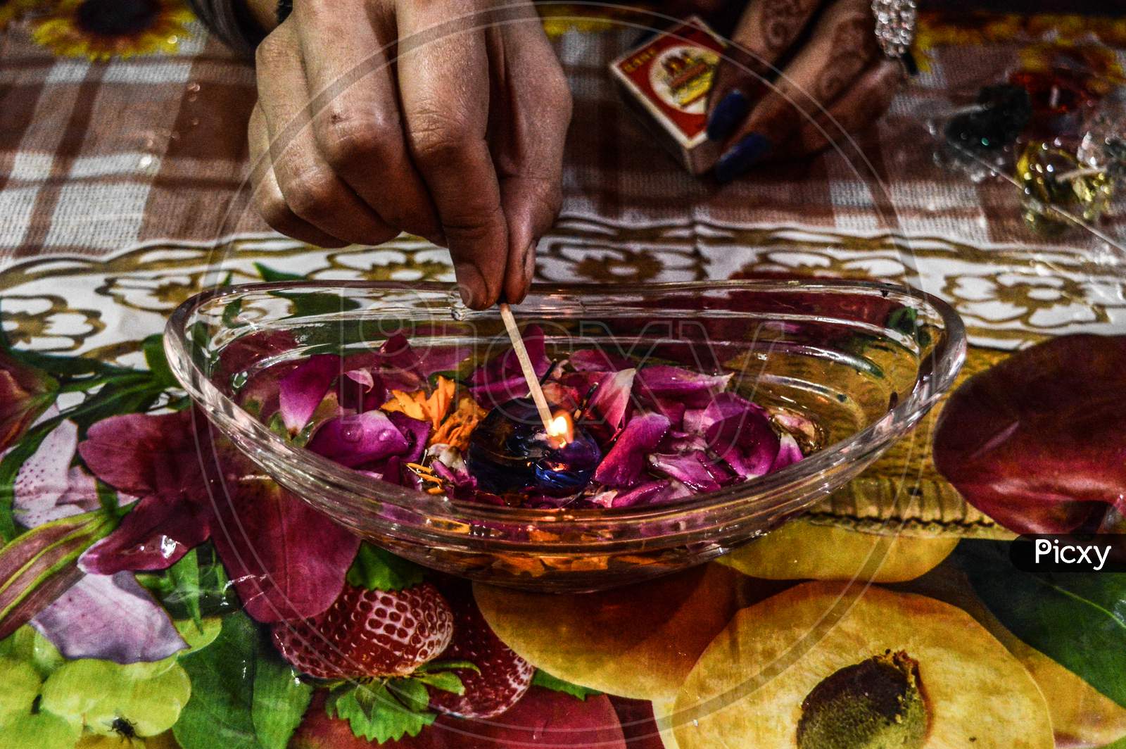 A Indian Lady Lit Up A Jar Is Which Is Loaded With Rose And Candle On Indian Festival Diwali Deepawali With Fire Isolated On Table