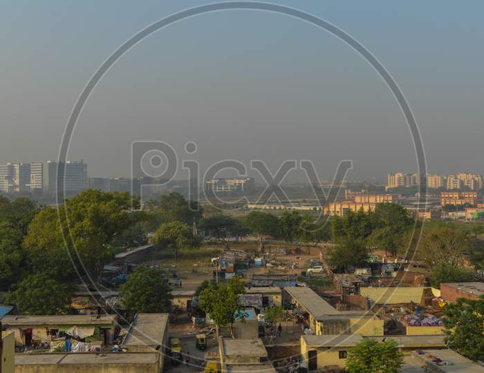 A Foggy Morning Landscape View Of City Submerge Of Polluted City And Unpolluted Village.