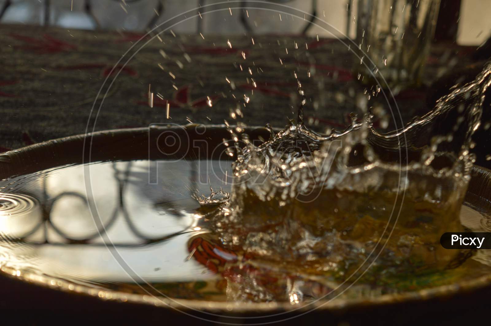 A Splash Photography Of Water Of Glass At Sunset Time.