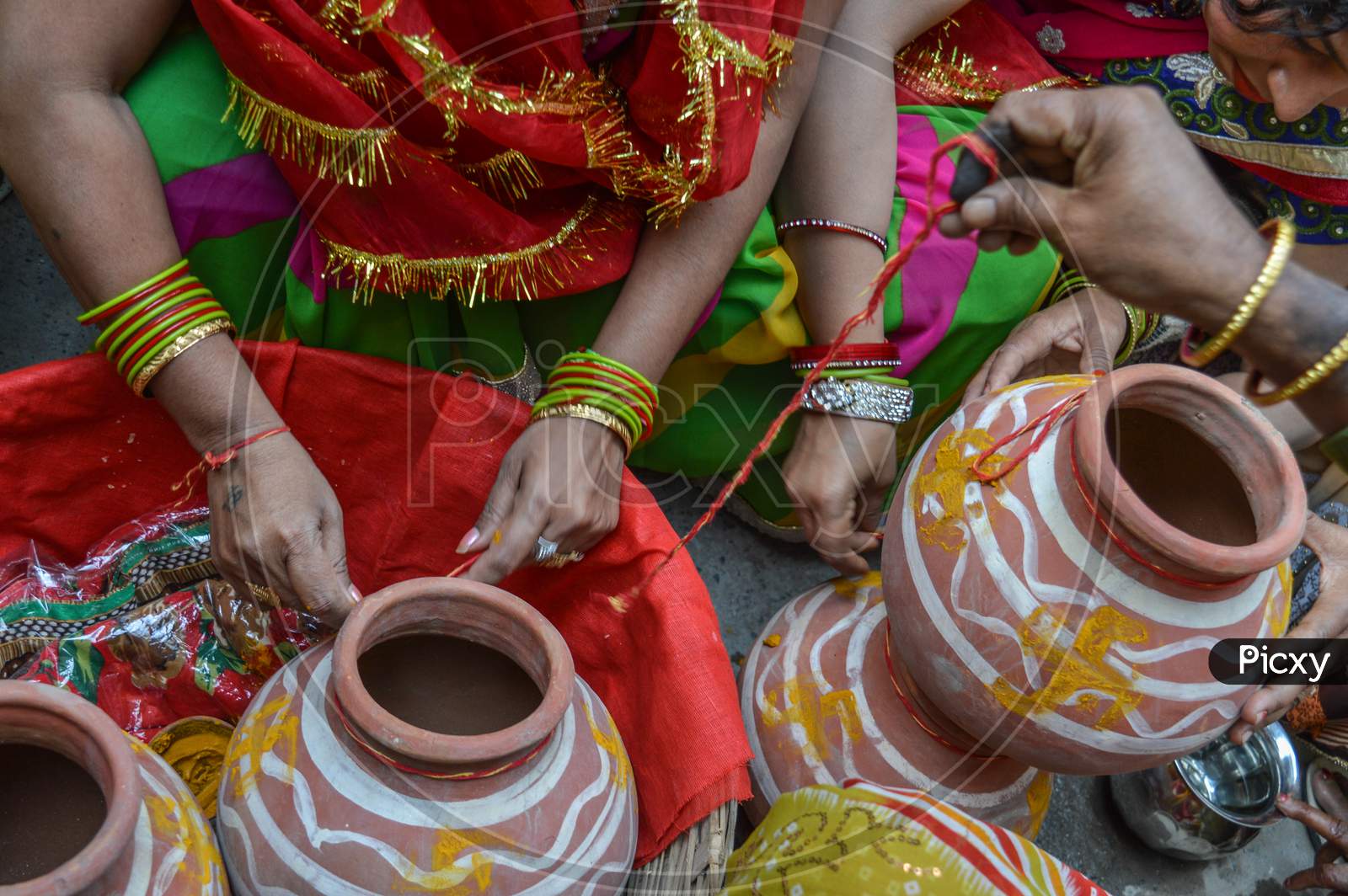 Lady Tie Thered On Clay Pot In Indian Weddings.