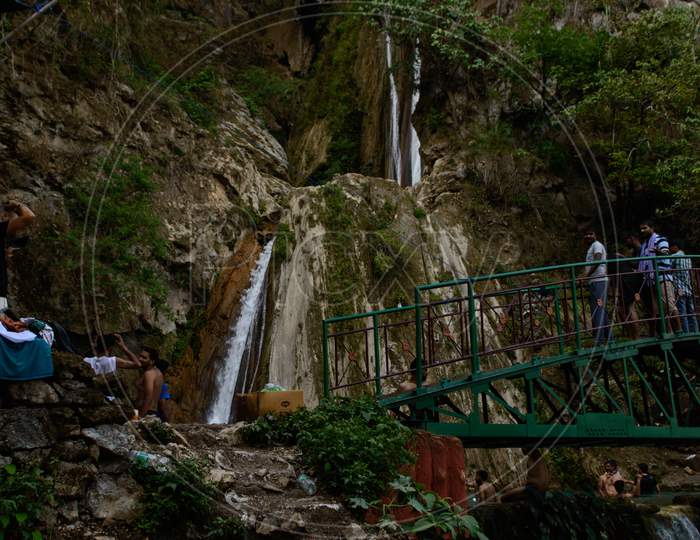 Group Of People Enjoying Under The Famous Neer Garh Waterfall, Rishikesh, Uttarakhand India.