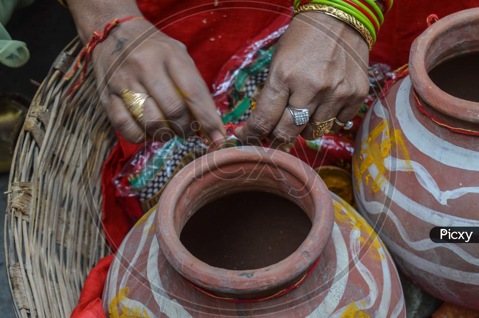 Lady Tie Thered On Clay Pot In Indian Weddings.