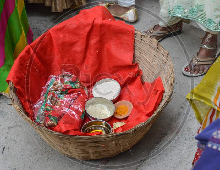 A Basket Loaded With Turmeric, Rice, Floor, Mustard Oil. Red Cloth In Indian Marriage.