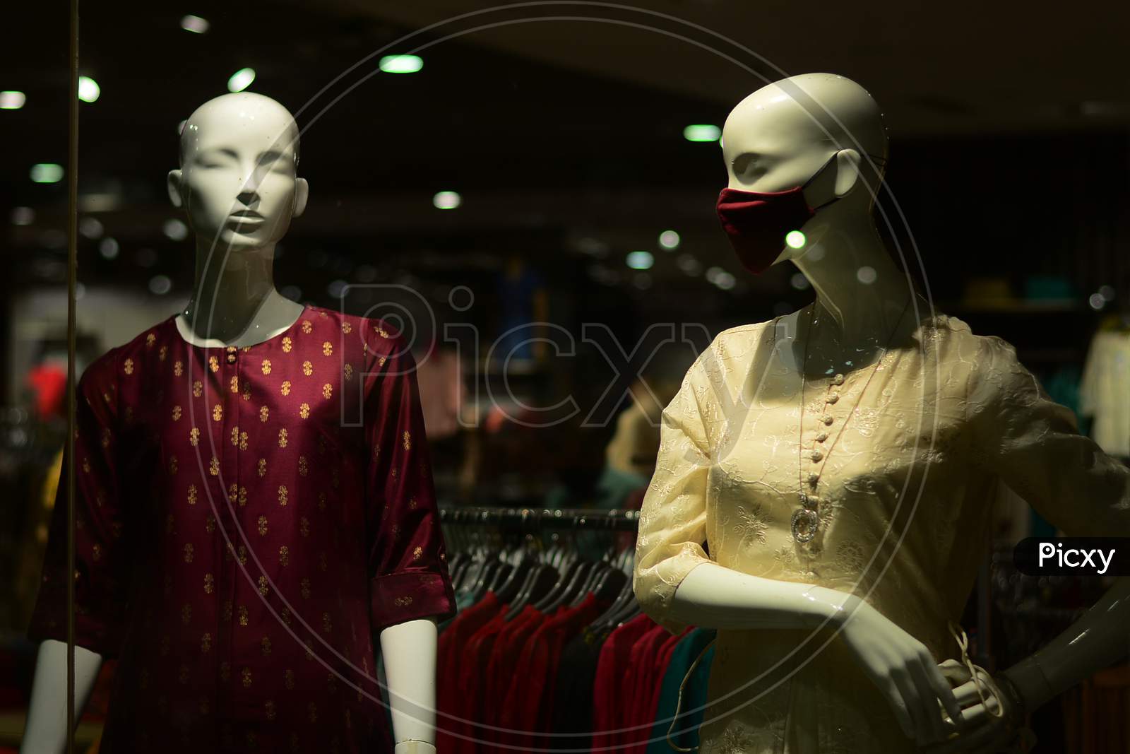 Salwar And Mask Are Displayed On Two Mannequin In A Garment Store