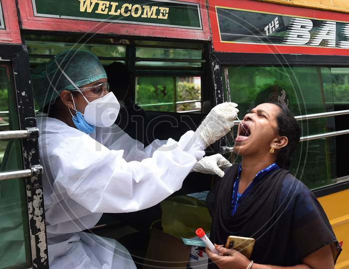 A Health Worker Wearing Personal Protective Equipments (Ppe) Suit, Sits In A Share Auto-Rickshaw As She Collects A Swab Sample From A Women To Test For The Covid-19 Coronavirus, Outside A Commercial Centre In Chennai On September 15, 2020.