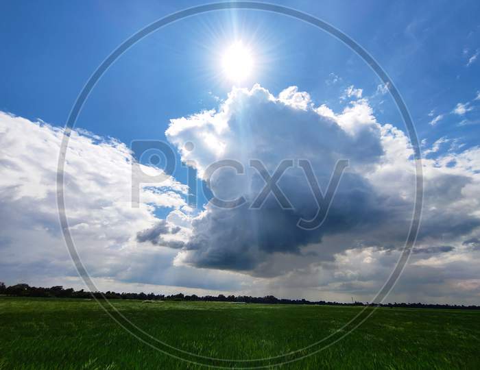 Sun with clouds, grassland