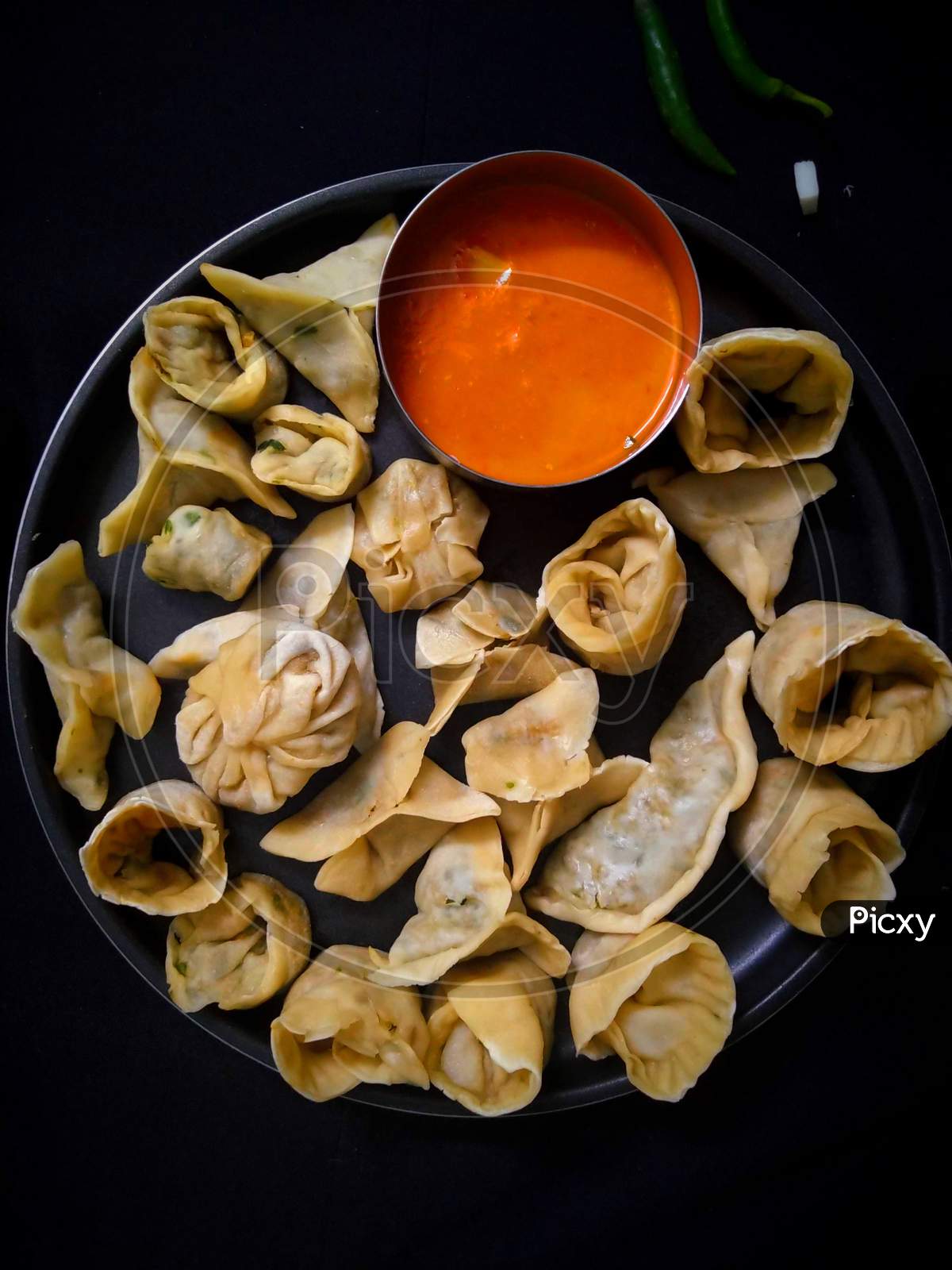 Asian veg steamed momo with spicy red tomato sauce.